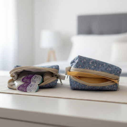 Two small Blue Floral fabric pouches on a surface with a blurred background